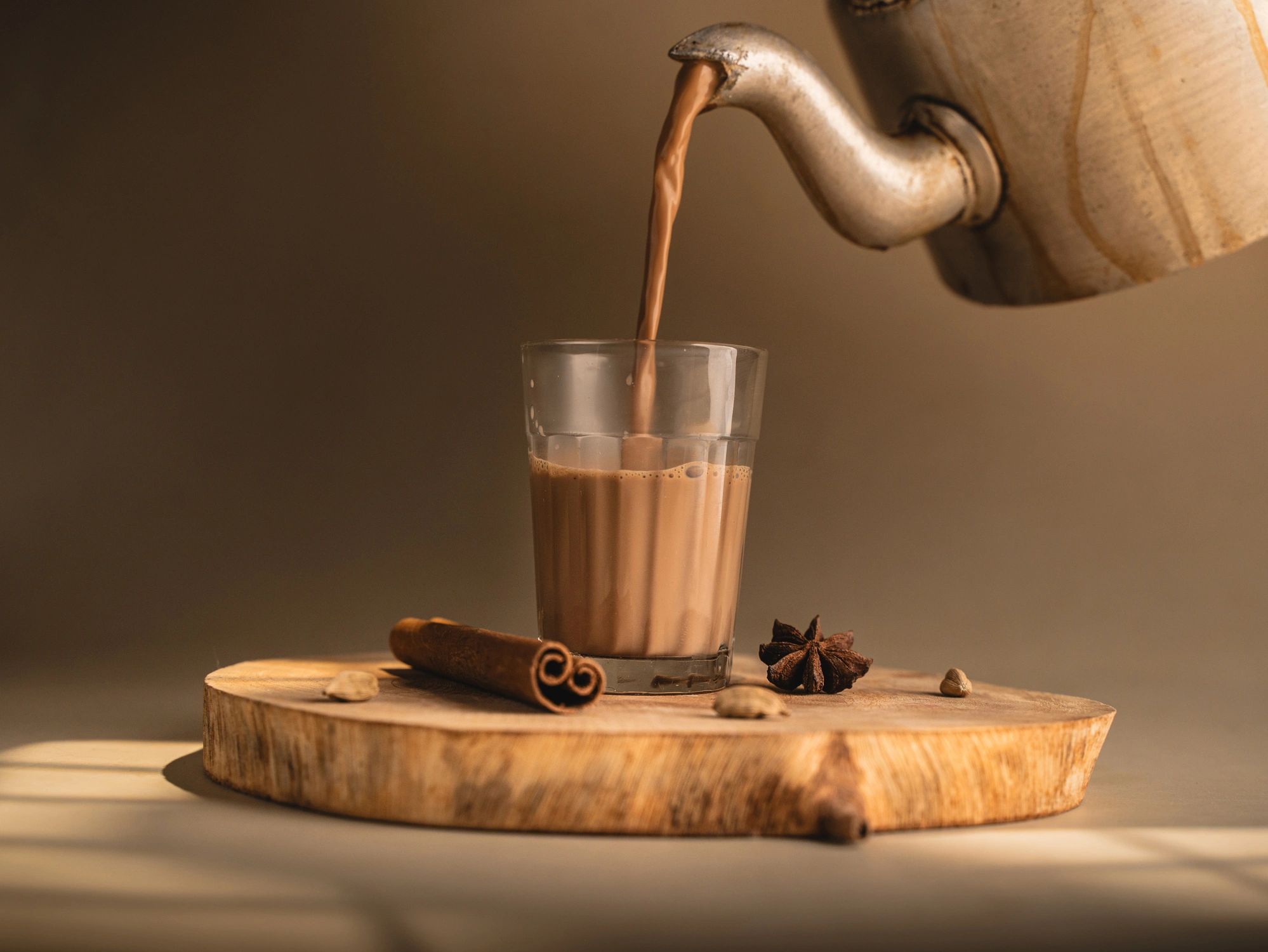 Traditional chai served in glass cups with a kettle